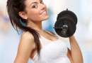 portrait of a young pretty woman holding weights and doing fitne